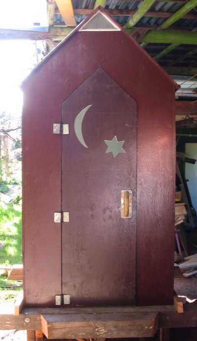 front of the outhouse