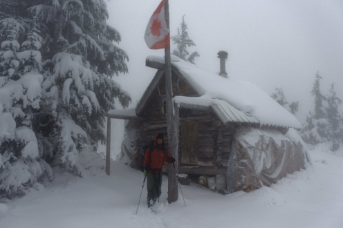 VOC Trip at the start of winter with plastic covering wood supplies on each side of the hut, 2017